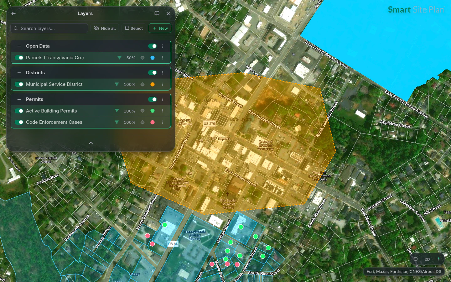 A downtown municipal service district: county parcels, active building permits, and code cases stacked in the Layers panel
