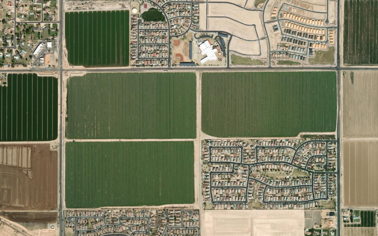 A desert solar array and construction corridor near Buckeye, Arizona, with field inspection submissions pinned by GPS
