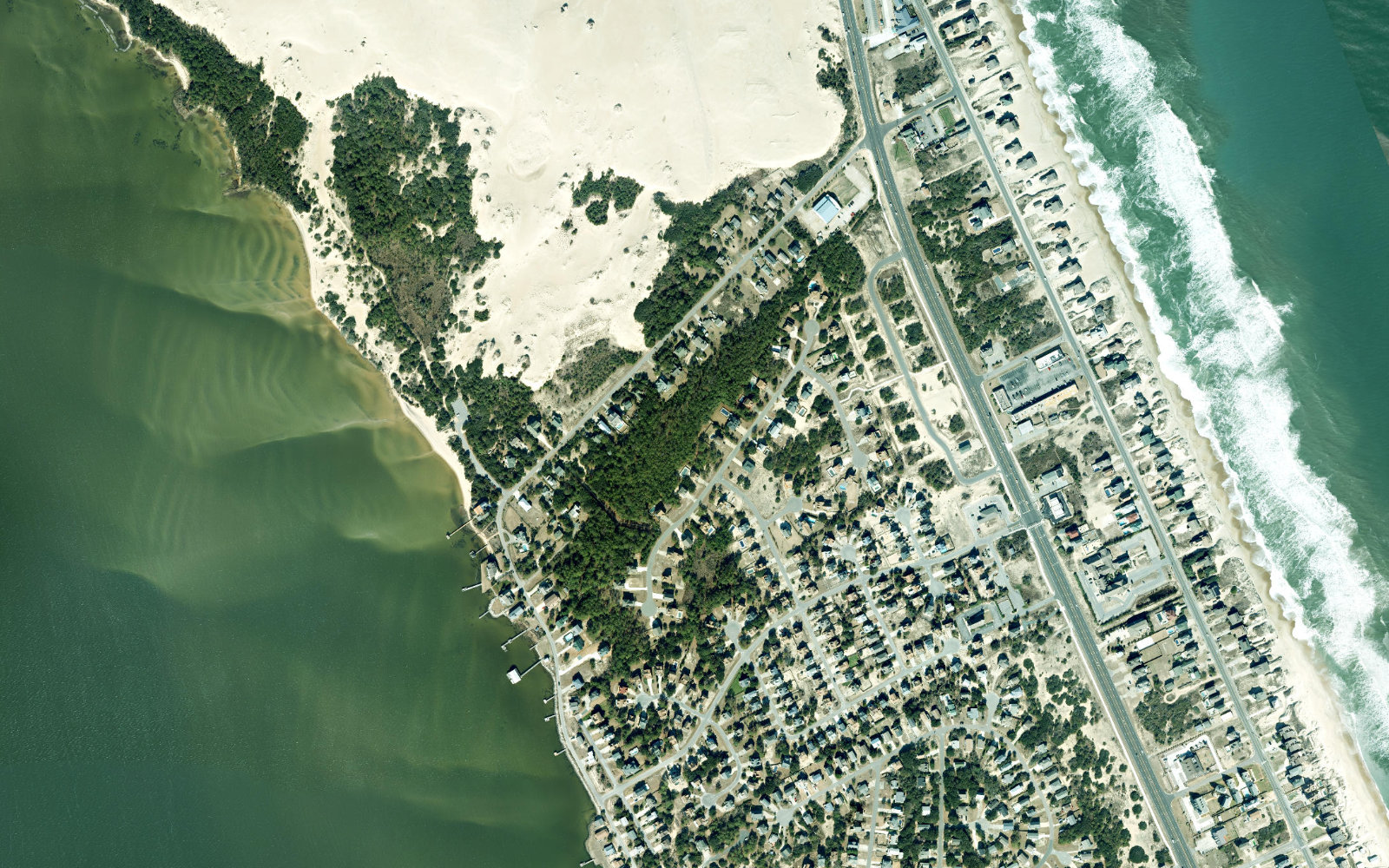 Aerial satellite view of a developed strip of Nags Head on the Outer Banks, ocean to the east and Roanoke Sound to the west